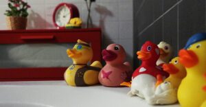 rubber ducks on a bathtub edge. Photo by George Becker: https://www.pexels.com/photo/assorted-rubber-duckies-on-white-surface-122308/